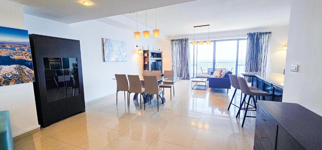 a kitchen and dining room with a table and chairs at Spacious Seafront 3-Bedroom Apartment in Sliema SV 3 in Sliema