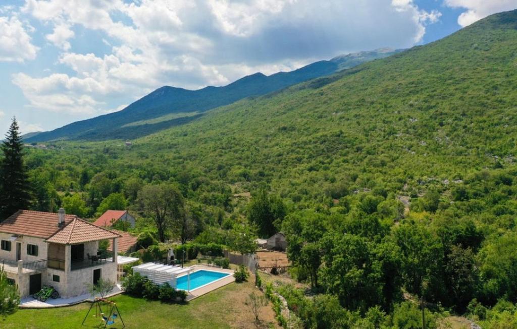 an image of a house in the mountains with a swimming pool at Villa Monteneze by Villas Guide in Zagvozd