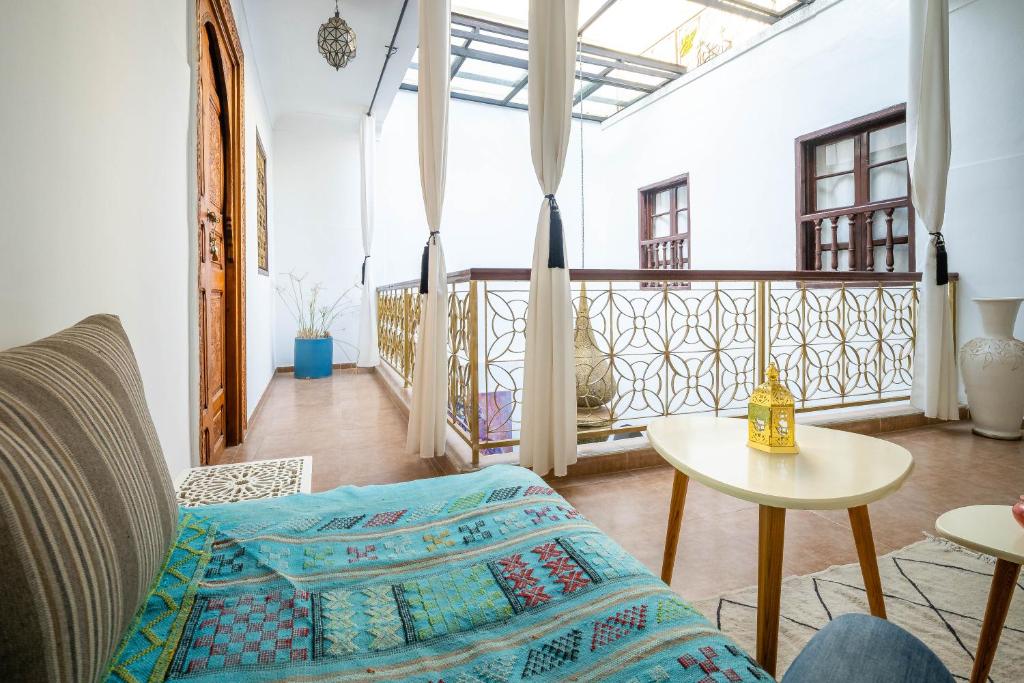a living room with a couch and a table at Riad Dekkak in Marrakech