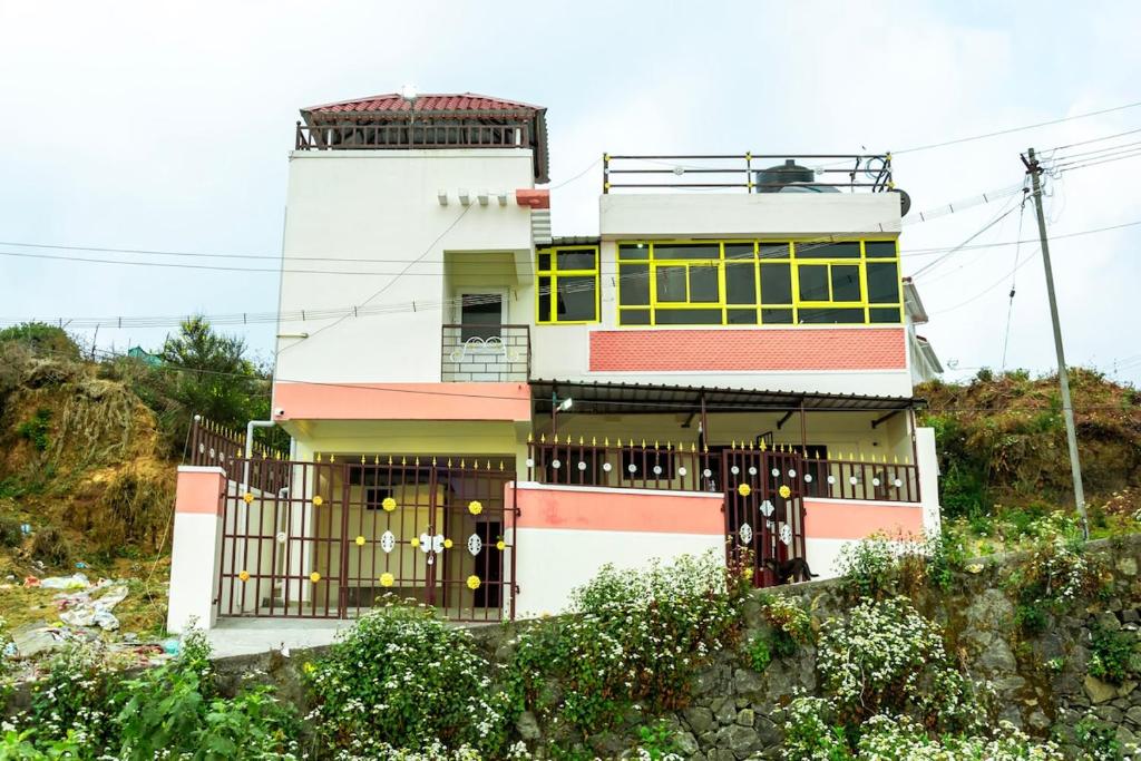 a house with a gate in front of it at December Holiday inn III bedroom home in Kodaikānāl