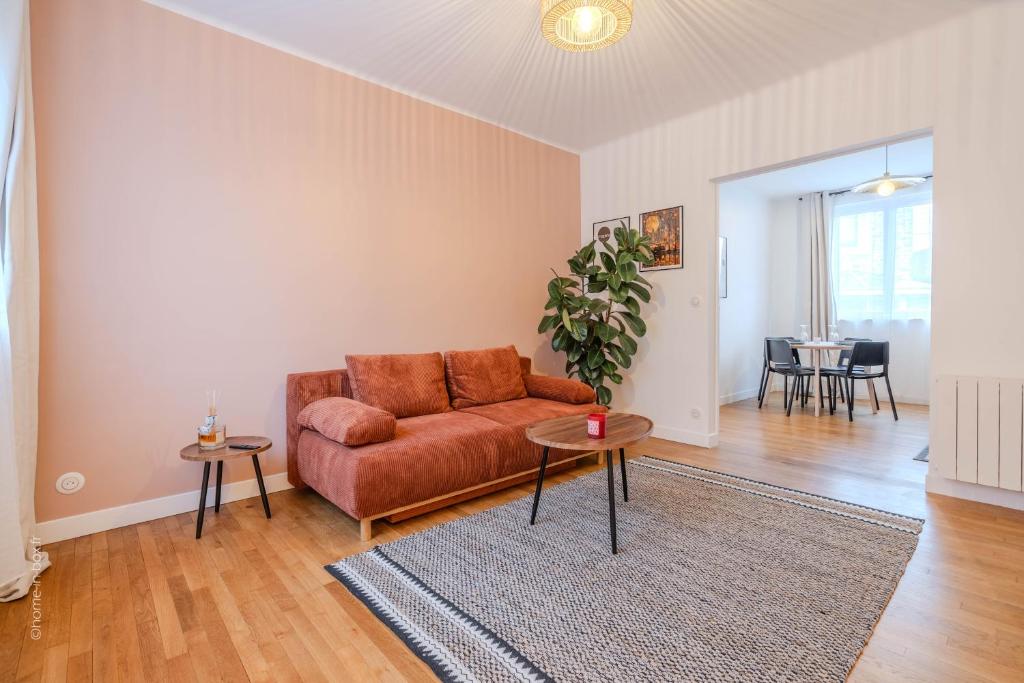 a living room with a couch and a table at Home designed Especially for Groups in Vaires-sur-Marne