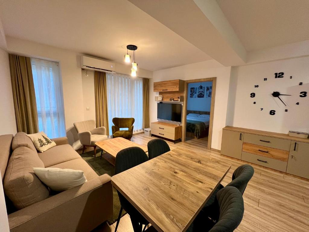 a living room with a couch and a table at Titik Apartments Mavrovo in Mavrovo