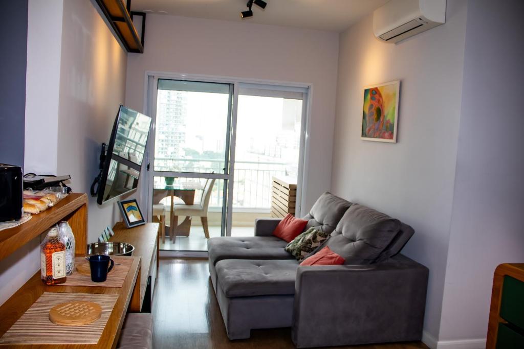 a living room with a couch and a table at Modern apartment in Pinheiros and Faria Lima in Sao Paulo