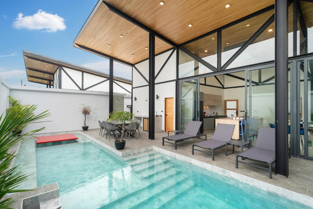 an image of a house with a swimming pool at Stylish Eco Villa Sunset Garden 1E with Private Pool near Nai Harn Beach in Ban Saiyuan (1)