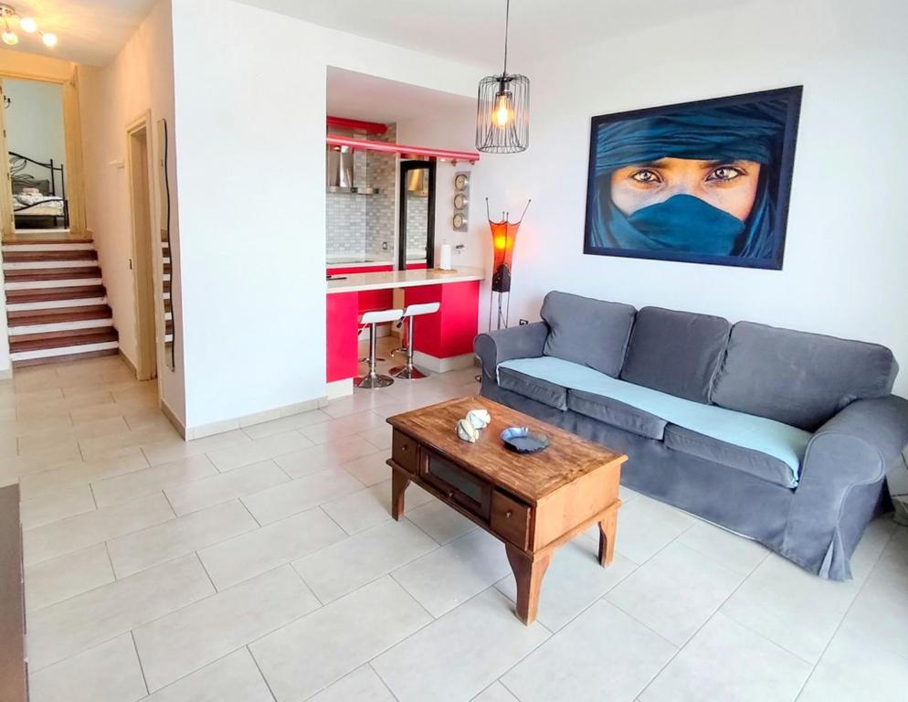 a living room with a couch and a table at Casa Cuba in Morro del Jable