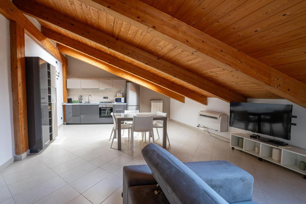a large living room with a table and a kitchen at NAP Luxury Apartment in Naples