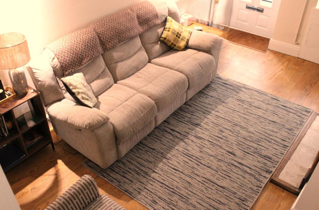 a living room with a couch and a rug at Charming 2 bedroom cottage in Brecon - families and pets welcome! in Brecon