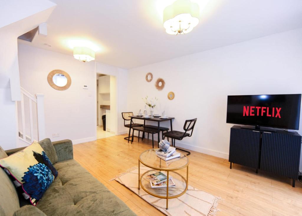 a living room with a couch and a table at Modern Hemel Home Ideal for Families & Workers Parking in Hemel Hempstead