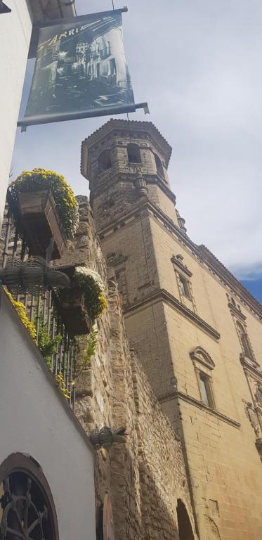 a building with a clock tower on top of it at La Casa del Pintor - Estudio de Arte en Baeza in Baeza