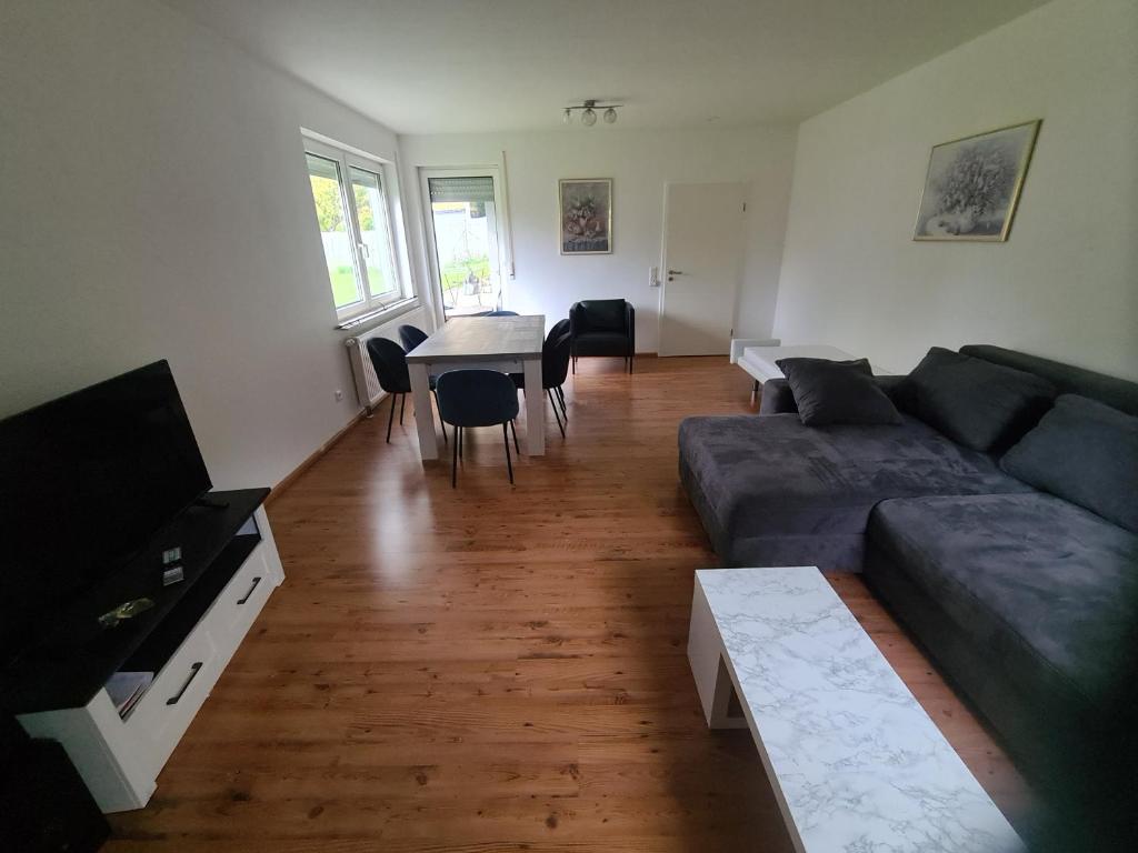 a living room with a couch and a table at Ferienwohnung Oskar in Gschwend