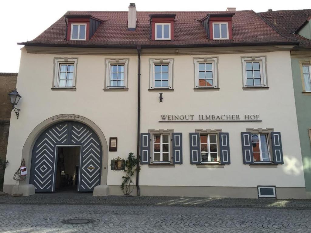 a large white building with a large doorway at Weingut Ilmbacher Hof in Iphofen