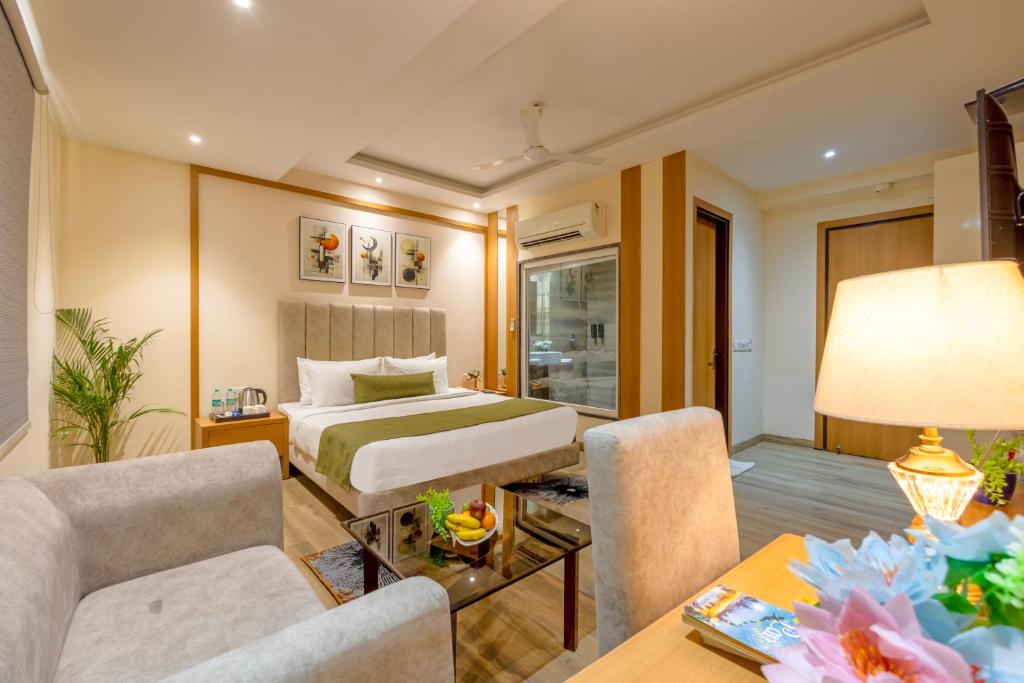 a bedroom with a bed and a living room at OPO Horizon Stanley,Free Airport Drop in New Delhi