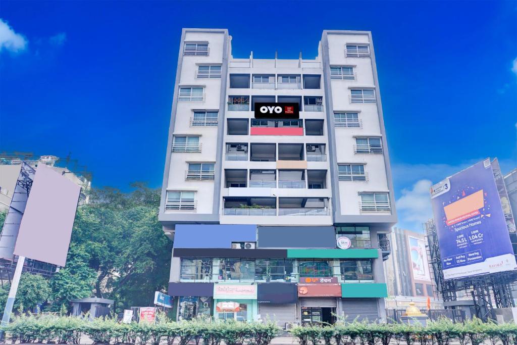 a tall white building with an oops sign on it at Hotel O EKAB Hospitality in Mundhwa