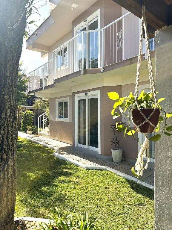 a house with a porch and a swing at Los Hermanos Residencial in Florianópolis
