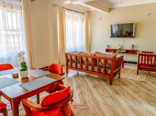 a living room with a table and a couch at Express living and wellness in Jinja
