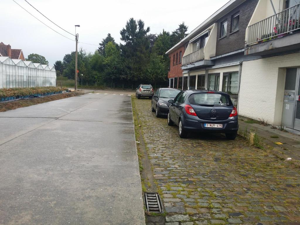 dos autos estacionados al lado de una calle en Residentie 't Leugentje en Grembergen
