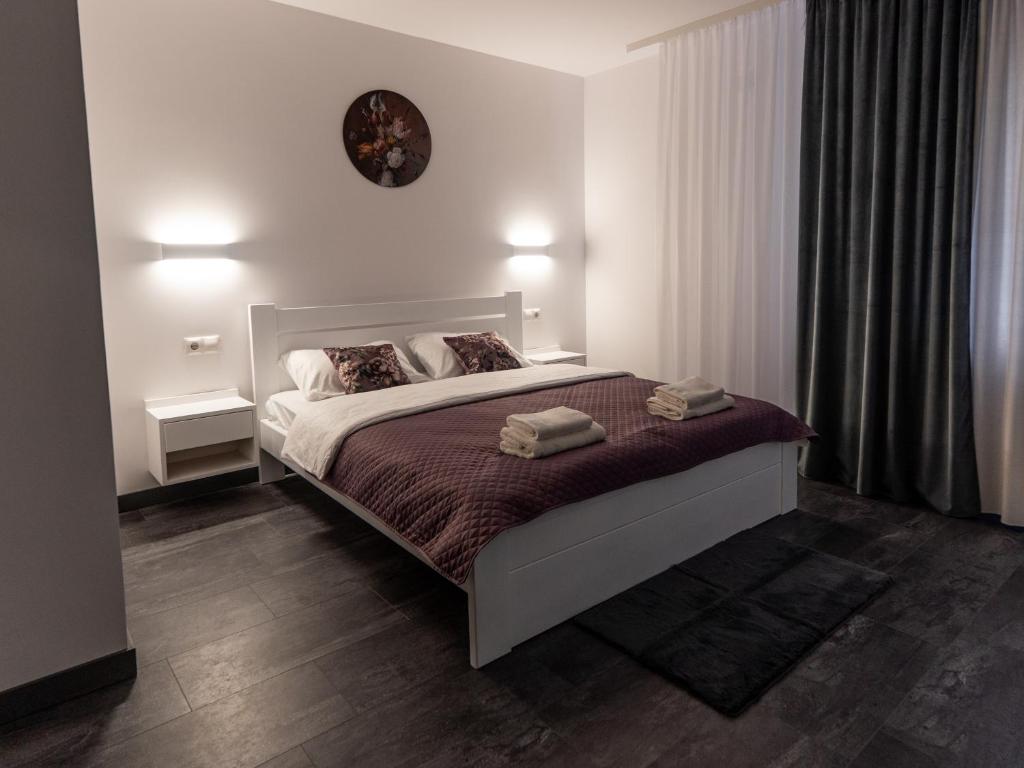 a bedroom with a bed and a clock on the wall at DREAM HOTEL Sambir in Sambir