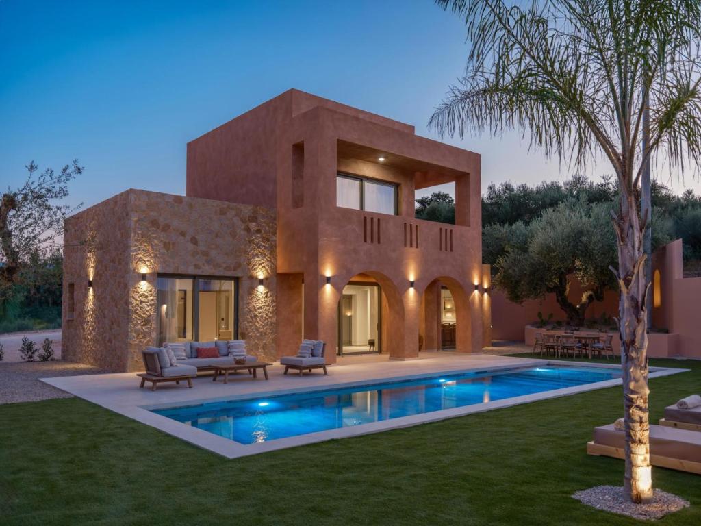 a house with a swimming pool in the yard at Gaia in Amoudi