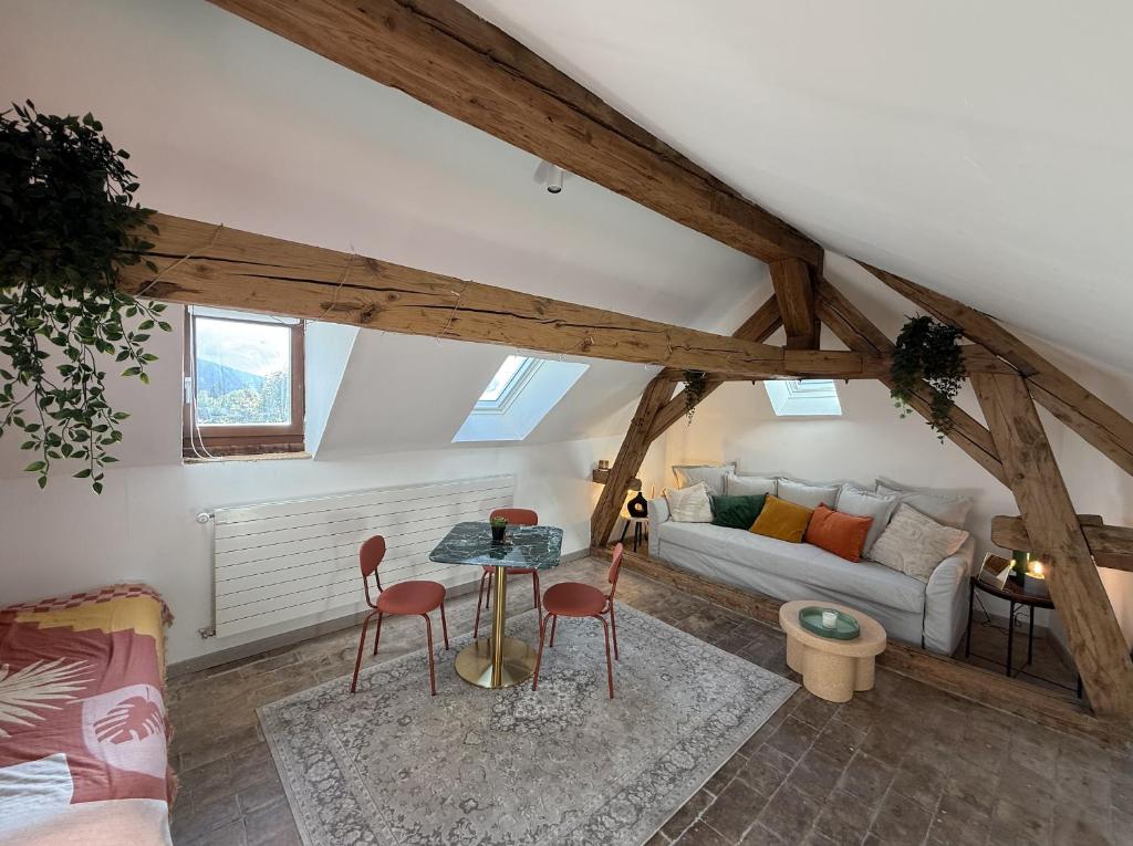 a living room with a couch and a table at Domaine à la Loëx in Geneva