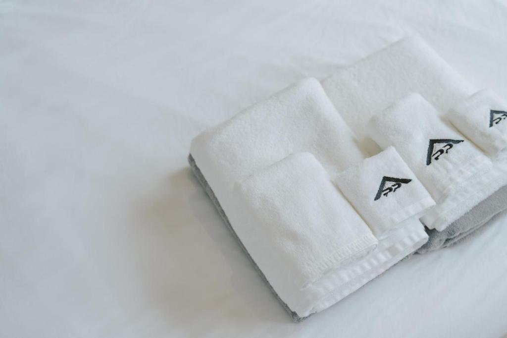 two white towels sitting on top of a table at Cassia Exclusive Lake View Condo Bang Tao Beach in Laguna Phuket