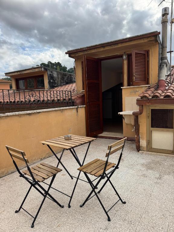 two chairs and a table on a patio at A Casa di Micol in Poggio Mirteto