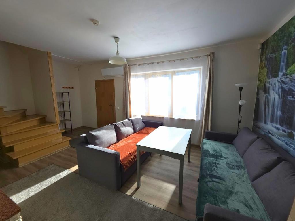 a living room with a couch and a table at Bistrycia in Vilnius