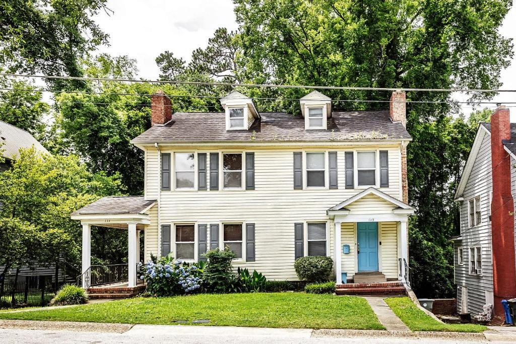an old house with a blue door on a street at The Woodside Guest House in Fayetteville