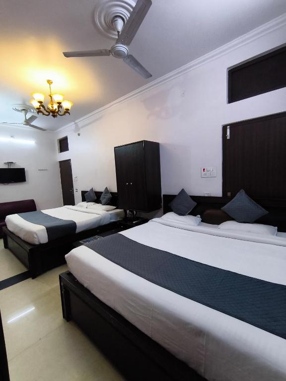 a hotel room with two beds and a ceiling at hotel blue star in Varanasi