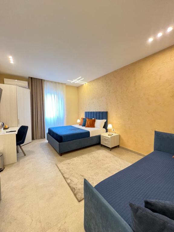 a hotel room with a bed and a desk at Partenope's House in Ercolano