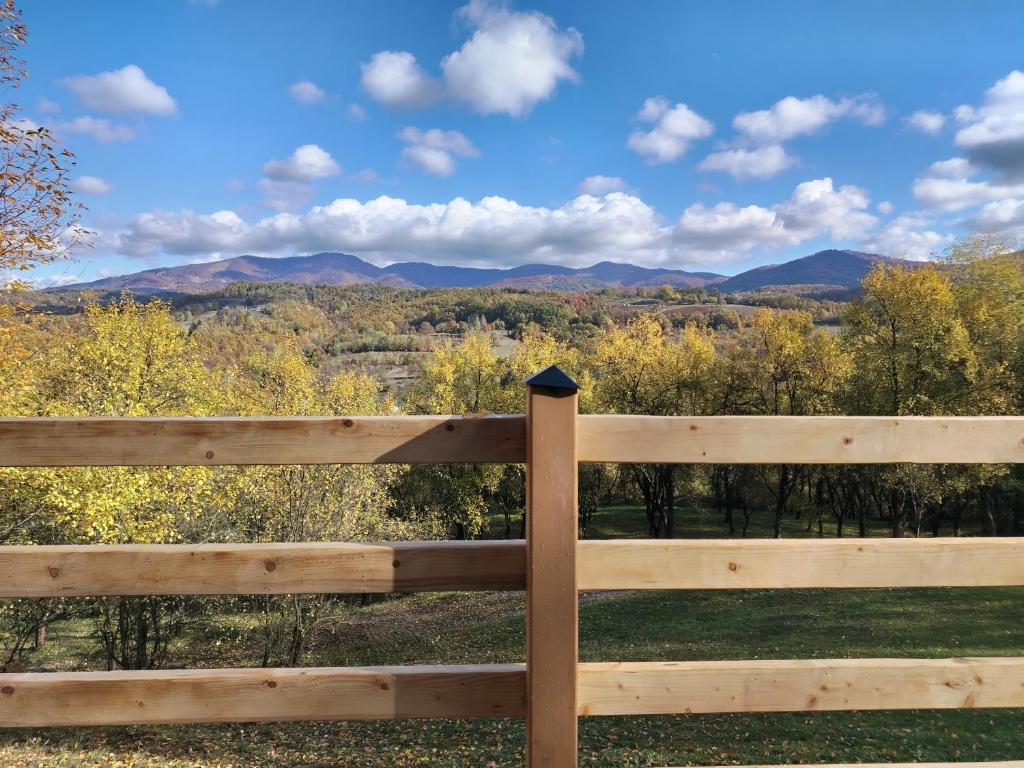 a wooden fence with a view of the mountains at MajdanskiKutak2 in Gornji Milanovac