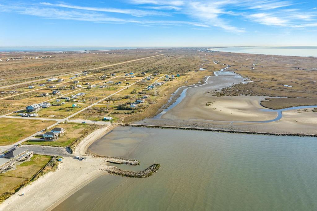 an aerial view of a beach and the water at Prime Beachfront Large Deck Family Fun in Port Bolivar