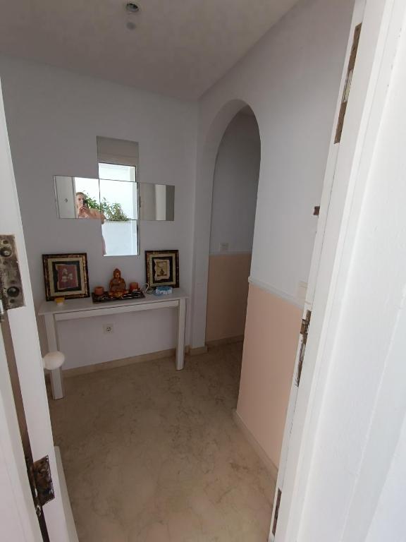 a hallway with a table and a window in a room at Apartamento Residencial mojacar in Mojácar
