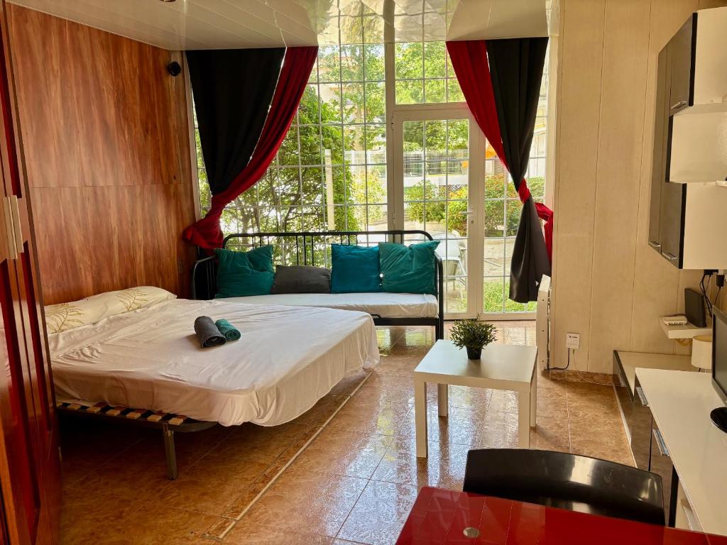 a bedroom with a bed and a large window at AlquilerSalou Loft B in Salou