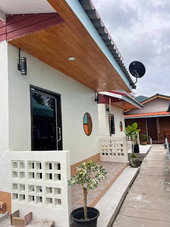 にあるKoh Libong Maldives Homestayの木造屋根のポーチ付きの家