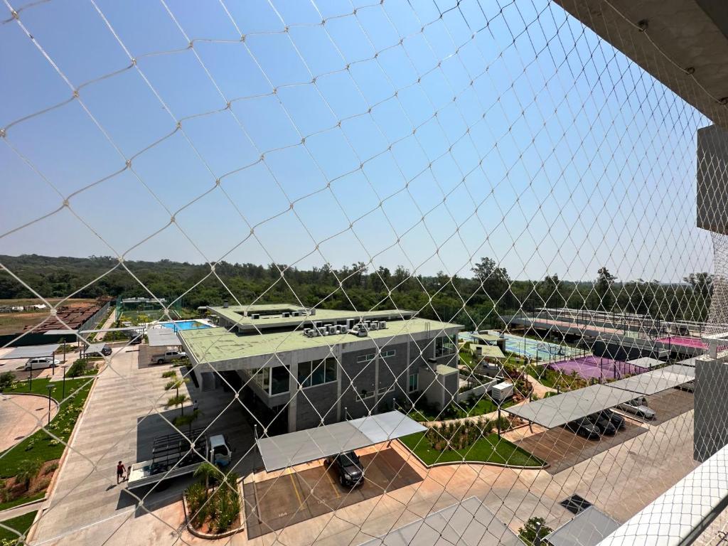 a view of a building from a net at Altamira Surubi-i in Estancia Sarubi