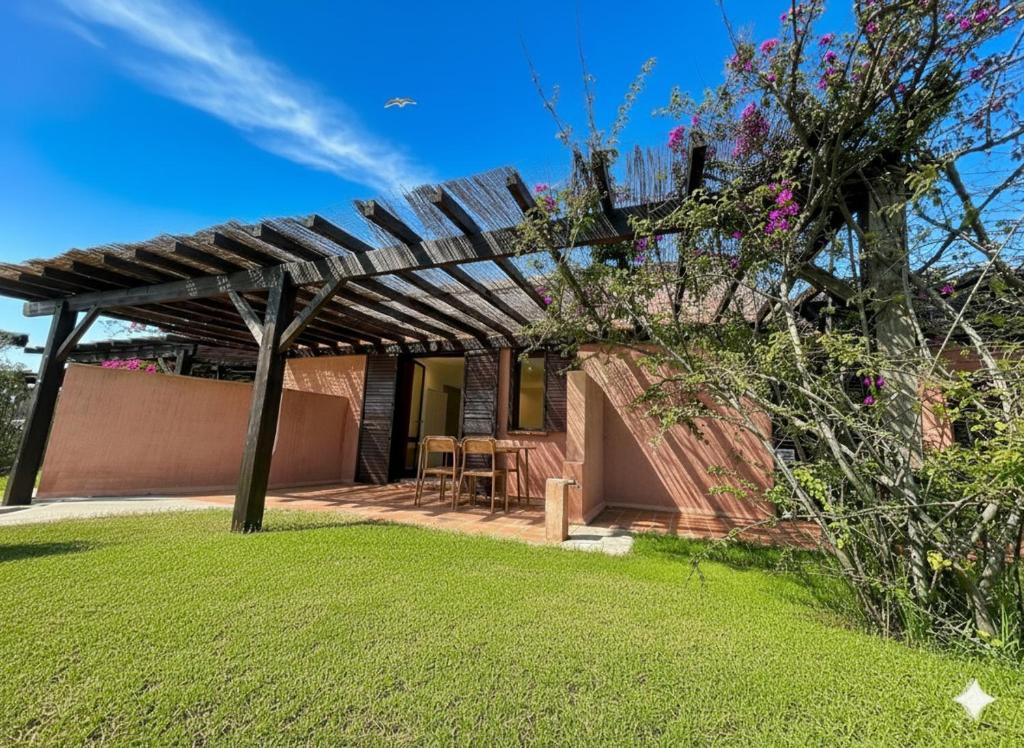 une terrasse avec une pergola en bois dans une cour dans l'établissement 8 ARBOUSIERS VILLA 20, à Bonifacio