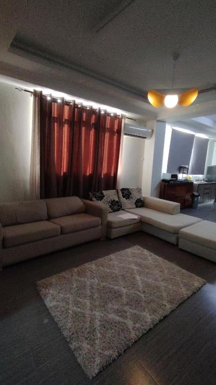 a living room with two couches and a rug at Seabeach residence in Belle Mare