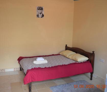 a bedroom with a bed with a red blanket at BNB Lanaelt houses in Nairobi