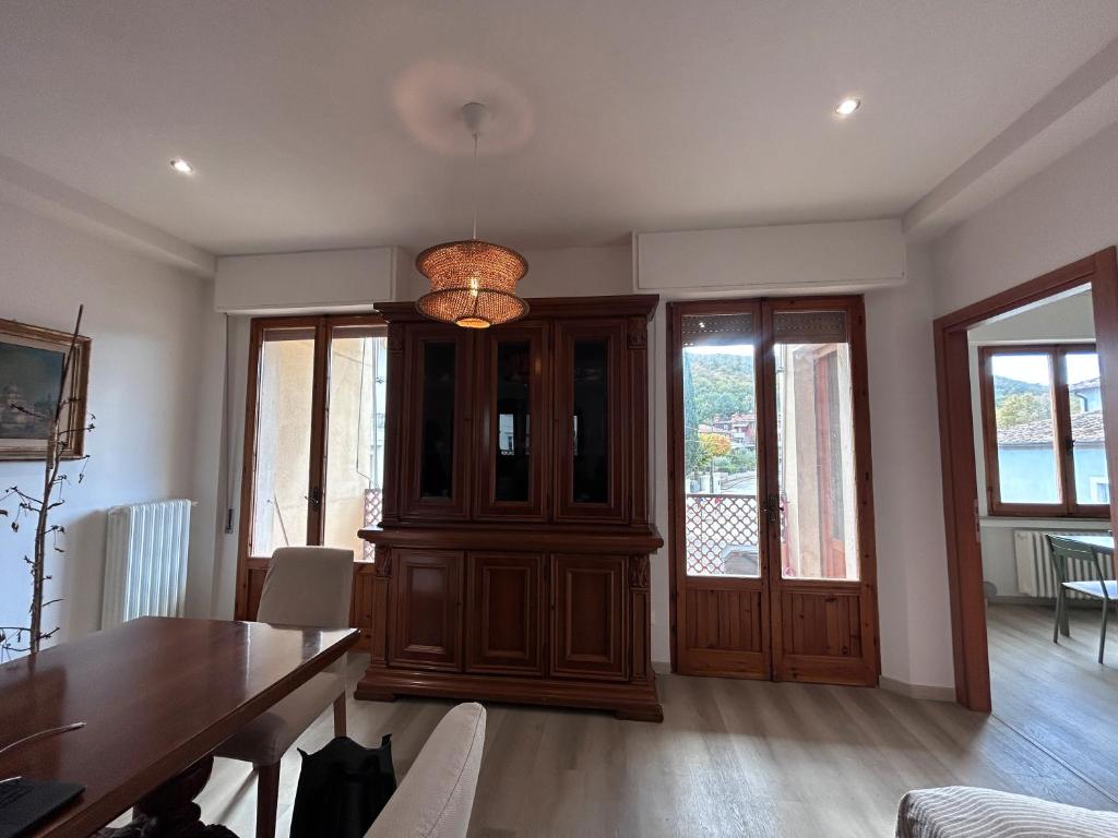 a dining room with a table and a chandelier at Dimore di Sant'Albino Montepulciano in Sant'Albino