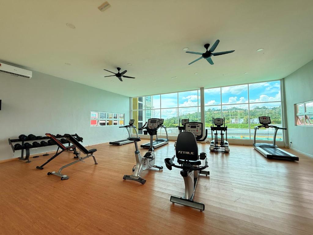 a gym with a lot of treadmills and exercise bikes at Mahkota Valley Suite, Lemmie Stay in Kuantan