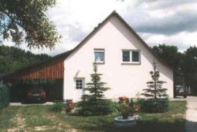a white house with two trees in front of it at Ferienhaus Dinse in Gützkow