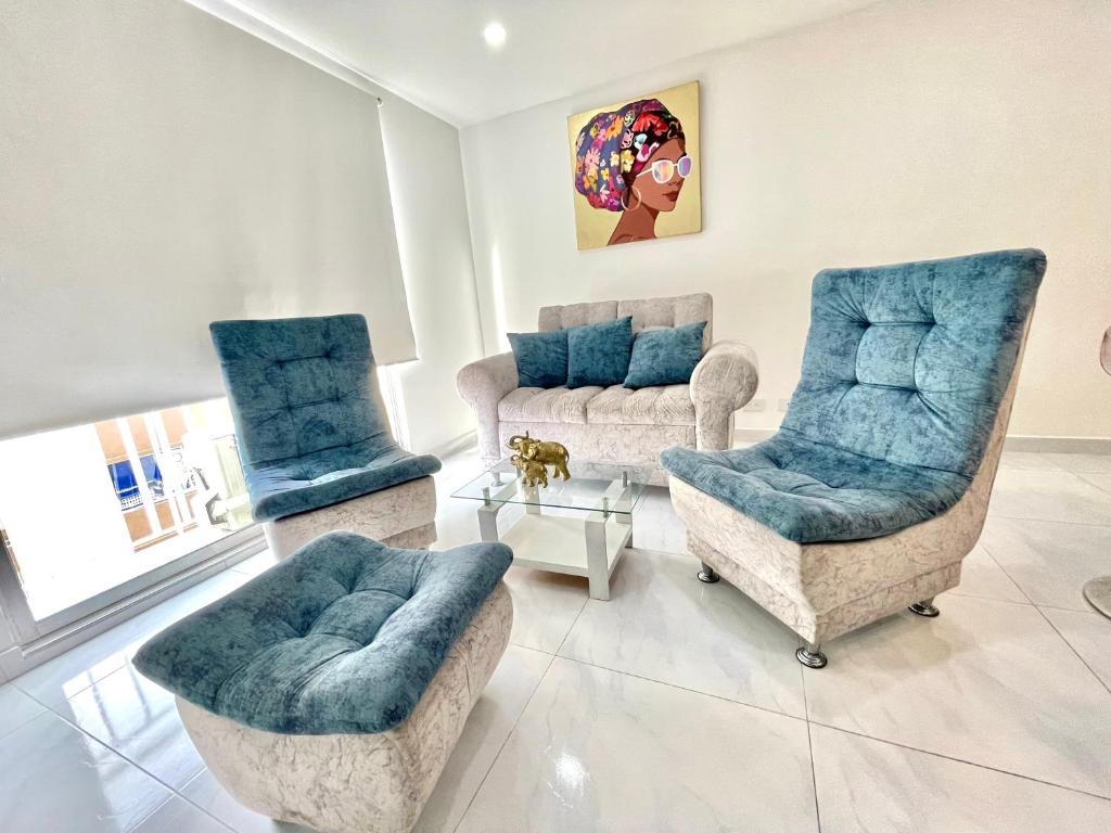 Una sala de estar con dos sillas y un sofá. en Loft Moderno con aire , con piscina T12, en Neiva