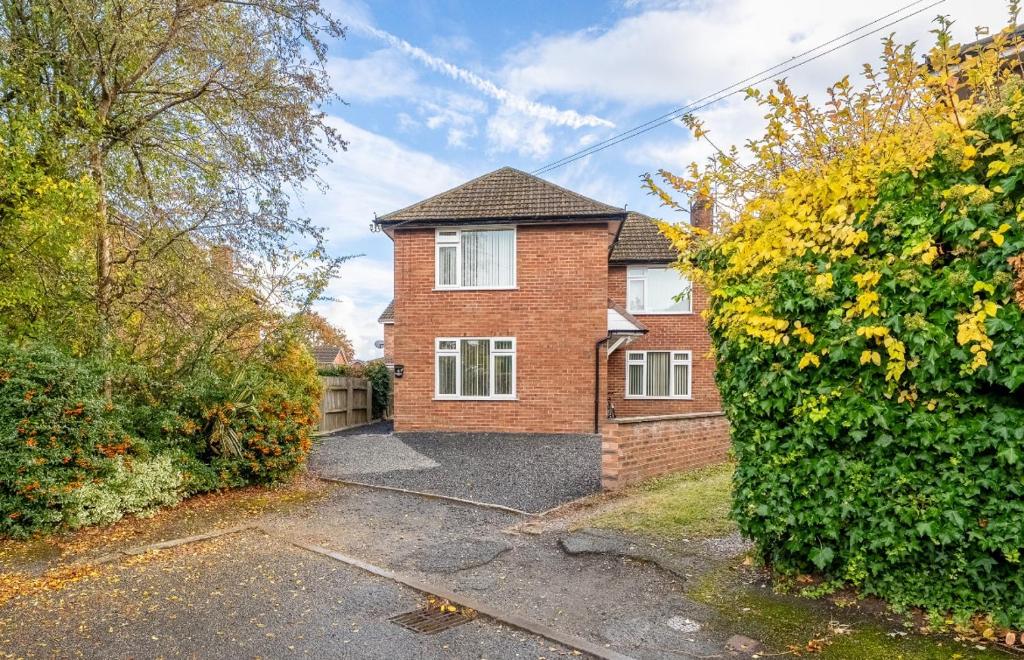 a brick house with a driveway in front of it at Spacious city centre Flat in the heart of Chester in Chester