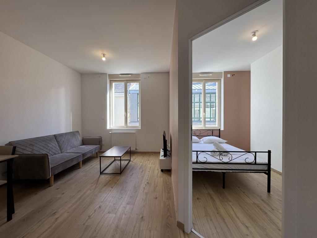 a living room with a bed and a couch at Le Repos Urbain - 3pers - Rêve au Mans in Le Grand-Lucé