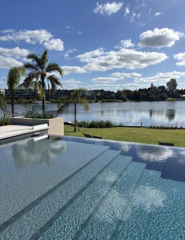 a swimming pool with a view of a lake at Monoambiente a 5 minutos del aeropuerto ESPECTACULAR in Montevideo