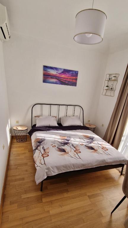 a bedroom with a bed with a blanket on it at Mirko's home 2 Studio Apartment in Podgorica