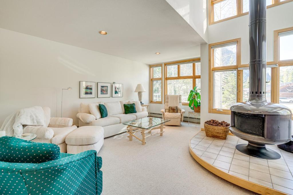 a living room with a fire place in the middle at Mtn-View Deck, Workspace! Walkable Frisco Condo in Frisco