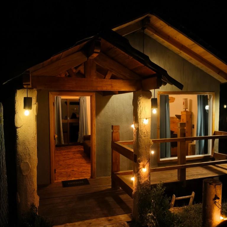 a house with a porch with lights at night at Cedrito in Mineral del Chico