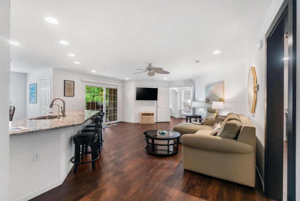 a living room with a couch and a kitchen at Lake Hideaway - Waterfront Condo with Resort Perks in Kimberling City