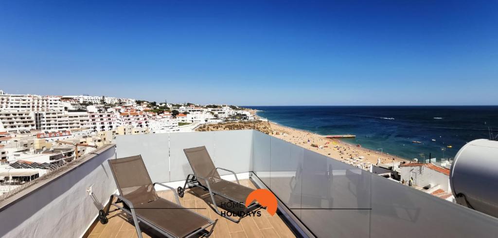 a balcony with two chairs and a beach at #098 Casa Antonieta 3 by Home Holidays in Albufeira